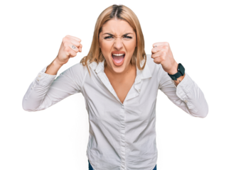Young caucasian woman wearing casual clothes angry and mad raising fists frustrated and furious while shouting with anger. rage and aggressive concept.