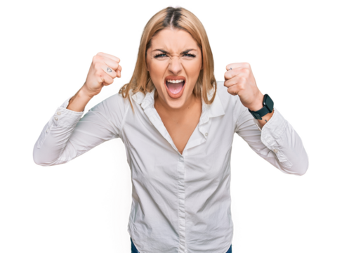 Young caucasian woman wearing casual clothes angry and mad raising fists frustrated and furious while shouting with anger. rage and aggressive concept.