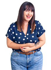 Young plus size woman wearing casual clothes smiling and laughing hard out loud because funny crazy...