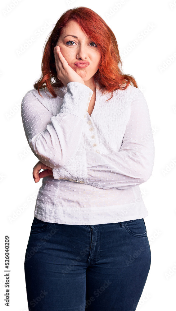 Wall mural Young beautiful redhead woman wearing casual shirt thinking looking tired and bored with depression problems with crossed arms.