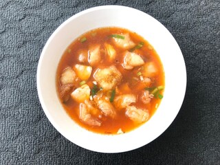 a serving of meatballs typical of Malang, East Java Indonesia. Isolated On a dark background