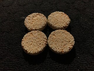 biscuits with sesame sprinkles isolated on a dark background