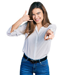 Young caucasian girl wearing casual white shirt smiling doing talking on the telephone gesture and...