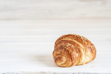 Sweet roll on white wooden background with copy space.