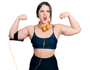 Young hispanic girl wearing sportswear doing strong gesture angry and mad screaming frustrated and furious, shouting with anger. rage and aggressive concept.