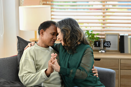 Romantic senior couple relaxing, enjoy weekend incopy living room together. Retirement lifestyle, health insurance concept