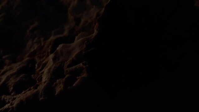 Lights Illuminated Rough Sedimentary Rock In The Dark. - close up, reveal