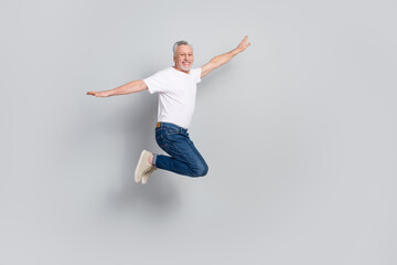 Full length body size view of attractive cheery free lucky man jumping flying isolated over grey pastel color background