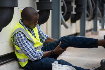 Male worker accident with broken leg at sewer pipes area at construction site. Health insurance...
