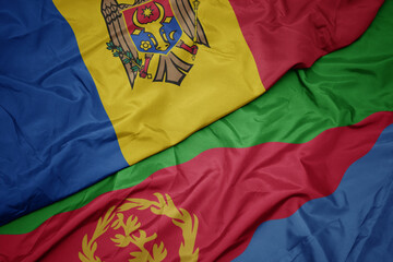 waving colorful flag of eritrea and national flag of moldova.