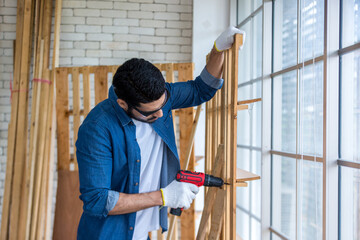 Carpenter working in carpentry shop. Carpenter working to making wood furniture in wood workshop 