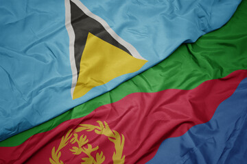 waving colorful flag of eritrea and national flag of saint lucia.