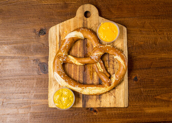 Soft pretzel with cheese and mustard