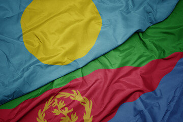 waving colorful flag of eritrea and national flag of Palau .