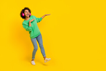 Full size portrait of overjoyed satisfied lady hands make moves dancing isolated on yellow color background