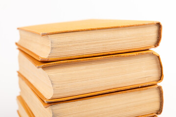 Stack of old books on light background. Book pile.