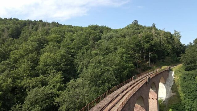 Drone Pullback revealing  view of Hubertus viaduct Train Bridge near Boppard, Germany with impressive blue sky
