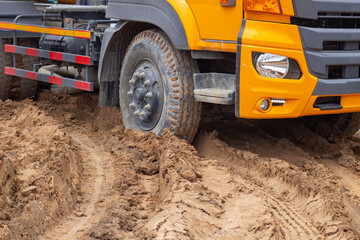 The country dirt road was muddy because the rain caused the car road is difficult for transport to pass.