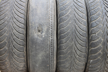 Old summer tire next to winter old tire