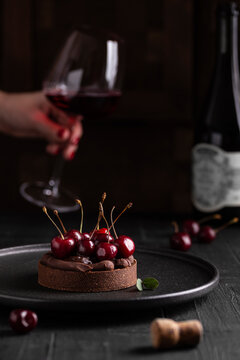 Chocolate dessert with berries and glass of wine