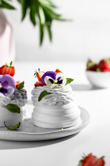 Meringue caked with pansies on a plate