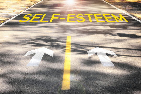 Self-esteem and arrow sign marking on road surface for giving directions. Boosting self esteem concept and improvement idea