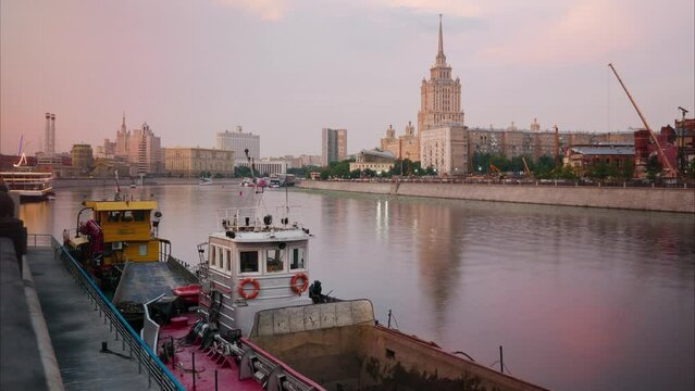 Sunset. Vessels for cleaning the river, are on the city pier. Cityscape in the background. Sunset. timelapse