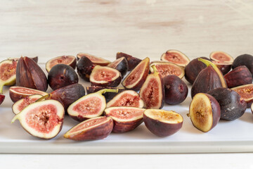 Cut up fig fruits on white background.