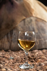 a glass of white wine in a wine cellar