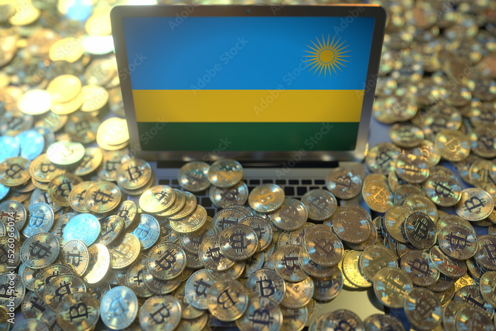 Poster laptop with flag of rwanda and pile of bitcoins. cryptocurrency mining and national regulations conc