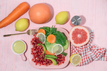 Healthy food vegetable salad in plate on pink background.