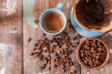 Coffee make with drip on wood table top view.