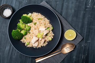 Healthy food fried rice with chicken breast have vegetable on wood table.