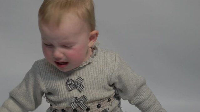 Slow Motion Sad baby sitting down and crying. 