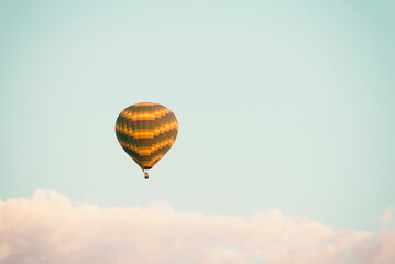 Hot air balloon over clouds