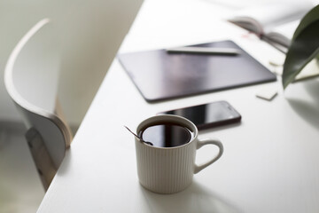 workplace  with  a tablet  and cup of coffee over white office background