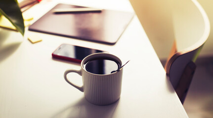 workplace background with cup of coffee and tablet