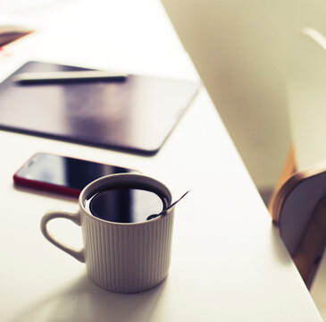 workplace background with cup of coffee and tablet