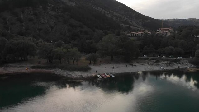 aerial shot of the coast of Lake Scanno in Abruzzo at sunset during a weekend day