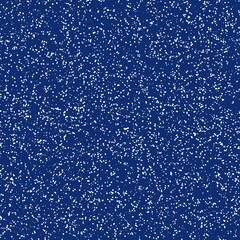 White speckled paper on a very dark blue surface.