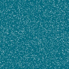 Fototapeta premium White speckled paper on a dark cyan surface.