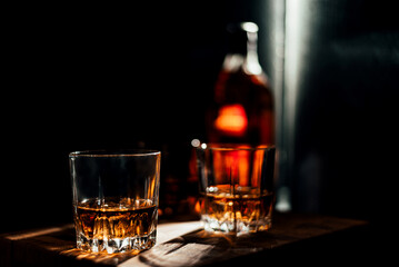 glass whiskey with bottle on background