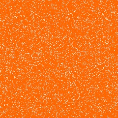 White speckled paper on orange surface