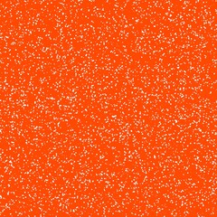 White speckled paper on vivid orange surface