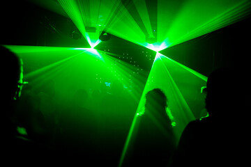 Green Laser Lights in a Dark Club – Silhouettes of Dancing People