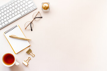 Work place office flatlay with golden colored office supplies, top view