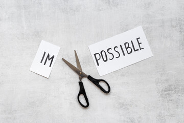 It is possible concept. Word Impossible becomes Possible with scissors