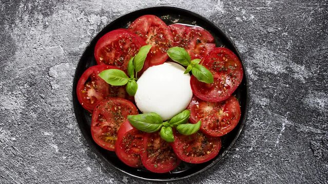 Burrata cheese served with fresh tomatoes and basil leaves traditional italian salad