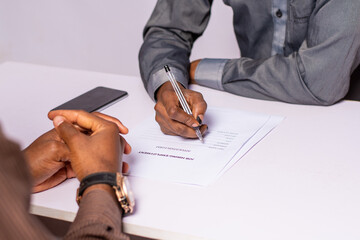 african man conducting a job interview writing