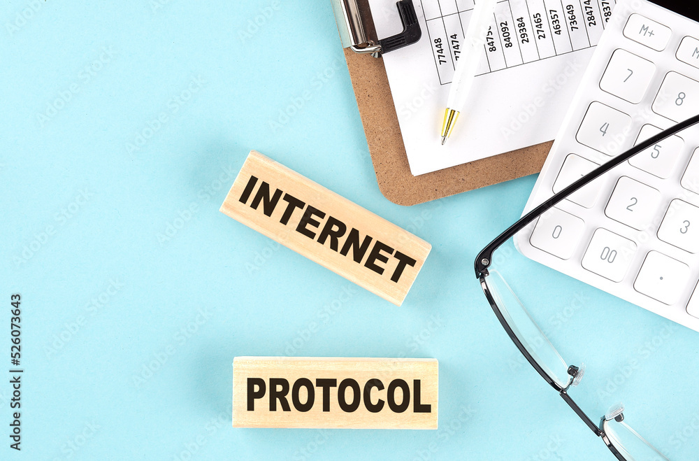 Poster internet protocol text written on wooden block with clipboard,eye glasses and calculator business co